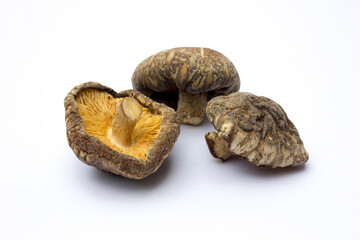 Dried shiitake mushrooms isolated on white background. They are a good source of vitamins, minerals, and antioxidants, and can potentially support immune function, heart health, and bone health.
