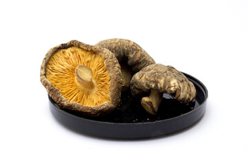 Dried shiitake mushrooms isolated on white background. They are a good source of vitamins,...