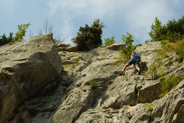 An interesting cliff in the province of Pescara, Abruzzo with compact limestone , equipped for free climbing . A novice climber  can be see on bear wall