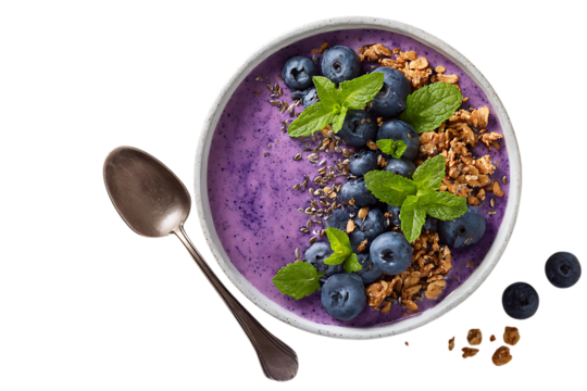 A vibrant blueberry smoothie bowl with granola, top view. The bowl is adorned with fresh mint leaves and flax seeds for an extra touch of freshness.