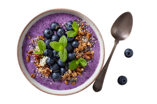 A vibrant blueberry smoothie bowl with granola, top view. The bowl is adorned with fresh mint leaves and flax seeds for an extra touch of freshness.