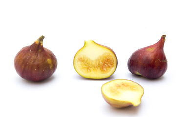 Three figs on a white background. Figs are high in fiber, which can help relieve constipation and promote a healthy digestive system.