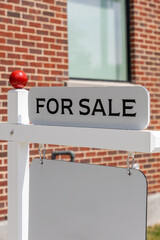For sale sign in front of a residential house