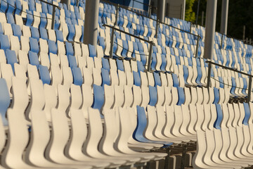 A row of blue and white seats located prominently in a stadium, designed for spectators, providing comfort and a great view of events