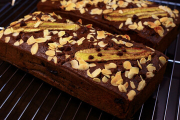 Overhead view of fresh homemade banana bread cooling on a shelf, showing close up details of banana bread slices with chocolate chunks, Banana bread or cake for breakfast and celebration cakes.
