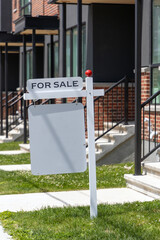 For sale sign in front of a residential building. Real estate market