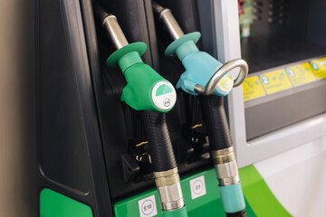 Fuel nozzles at modern gas station. Closeup of diesel and gasoline pump handles. Clean equipment...
