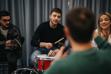 A group of musicians collaborating while practicing in a music studio setting, working together.