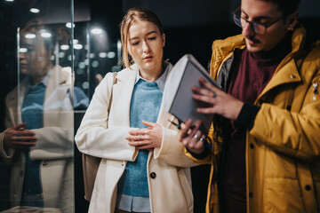 Young professionals engaged in discussion, collaborating on a project in a modern indoor setting,...