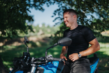 A smiling man sits on a blue motorcycle in a park, enjoying the sunny outdoors. The scene captures...