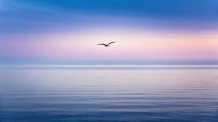 Fototapeta premium A serene seascape at dawn, featuring gentle waves and a solitary bird soaring against a pastel sky.