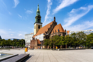 Berlin, Germany - 27 August 2019: View of the Marienkirche under a sky streaked with clouds, framed by the textures of stone and the urban landscape.