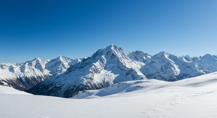 Majestic snow-covered mountains under a clear blue sky