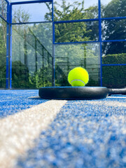 Competition-ready padel equipment awaits players on the pristine court surface, showcasing the professional aspects of this energetic sport. 