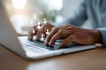 Hands typing on laptop with glowing people icons floating above the keyboard in a bright setting