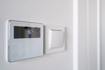 Sleek smart thermostat with digital display enhancing home energy efficiency