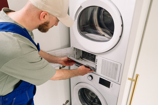 Expert technician for washing machine repair in modern laundry