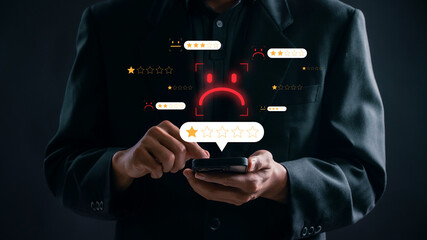Poor service rating feedback Concept. businessman using smartphone to give 1-star feedback,...
