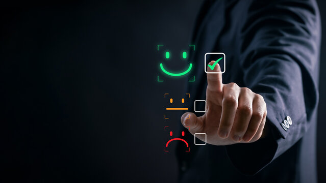 Customer Satisfaction Concept. Businessman selecting positive feedback icon on digital interface to evaluate service quality, improve customer experience, and enhance company reputation