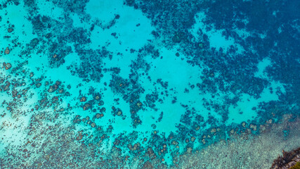 Stunning aerial view of the Surin Islands coastline with its lush green forests, coral reefs and deep blue waters filled with coral and a variety of fish, making it a popular destination for divers