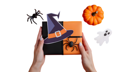 Halloween gift box: A pair of hands delicately presents a festive gift box adorned with classic Halloween symbols such as a witch's hat, spiders, pumpkin, and a ghost.