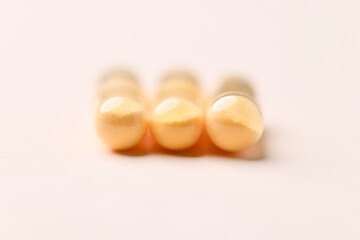 Coenzyme Q10 capsules. Antioxidants. Concept for a healthy dietary supplementation. Bright paper background. Soft focus. Close up. Copy space.