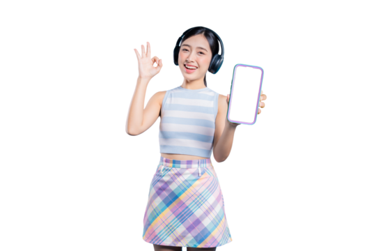 A cheerful young Asian woman with headphones, making an OK gesture while presenting a blank phone screen for an app mockup.on png 
