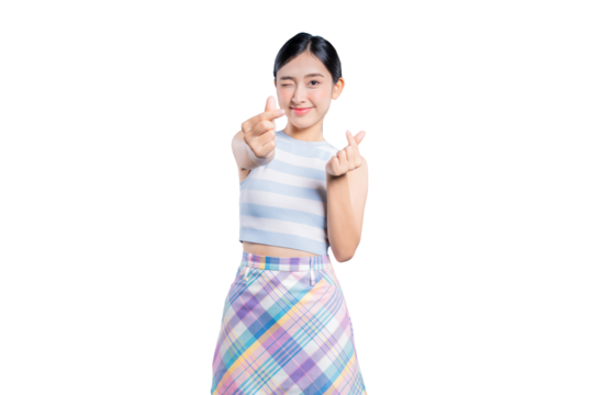 A playful young Asian woman winking and making trendy Korean mini heart gestures with both hands for the camera.
on png 