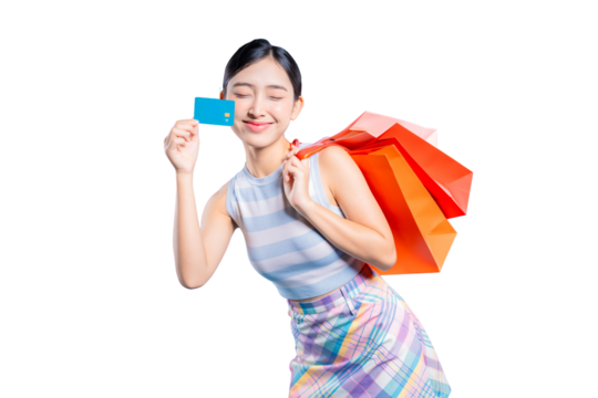 A blissful young Asian woman with shopping bags, holding a credit card with a happy and satisfied expression.on png 

