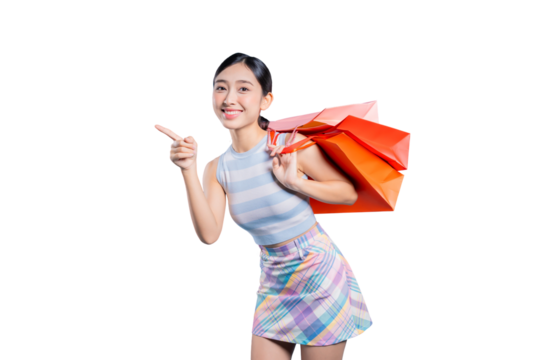 A happy young Asian woman with shopping bags, pointing to the side to show an exciting sale or product.on png 
