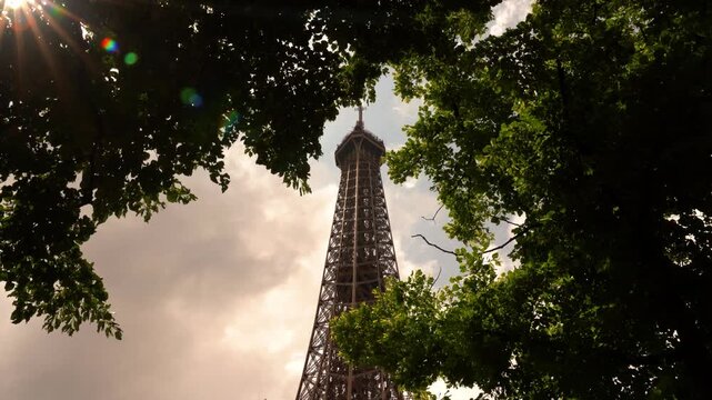 The iconic Eiffel Tower standing tall in Paris. Majestic French landmark, symbol of romance and elegance. Ideal for travel, tourism, and architectural footage.