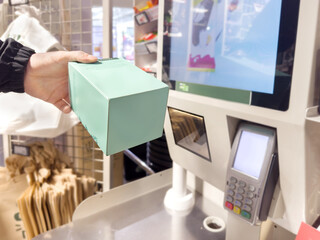 Self-checkouts or self-service checkouts,man paying for the purchases  in supermarkets