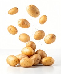 Fototapeta premium Fresh potatoes falling and piled together against a white background