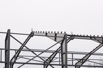 Metal construction, in the photo the structure of the building frame made of metal beams against...