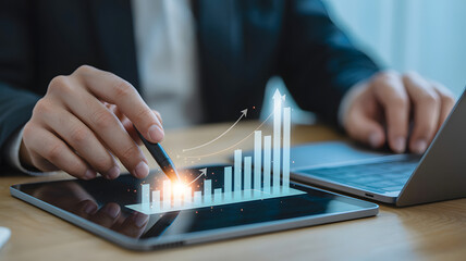 Financial analyst works on a digital tablet with a growth chart symbolizing investment success and business strategy.