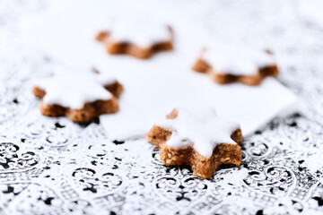 Christmas cookies (cinnamon stars) on bright background. Close up.	