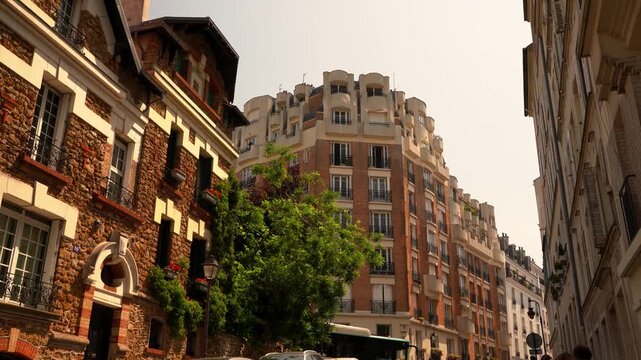 Classic Parisian apartment buildings with elegant balconies and stone facades. Iconic French architecture, ideal for real estate, travel, and lifestyle footage.
