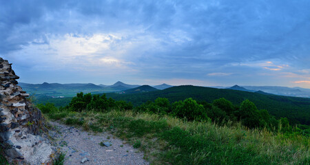 Rocky Summit Overlooking Czech Hills and Meadows under Soft Cloudy Sky