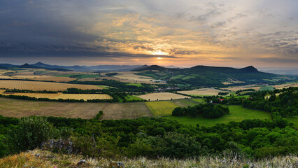 Rocky Summit Overlooking Czech Hills and Meadows at Gentle Sunrise with Soft Clouds