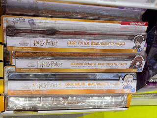Fototapeta premium Harry Potter Replica Wands Featuring Hermione Granger and Draco Malfoy Characters in Wizarding World Packaging on Store Shelves, Dnipro, Ukraine - June 20, 2025