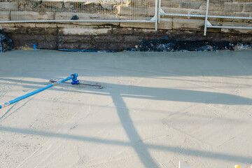 Skilled workers pouring and leveling concrete on a construction site