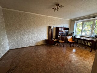 Old Soviet-Style Living Room with Vintage Furniture and Natural Light
