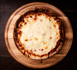 Pizza margherita on wooden background. Soft focus. Top view. Close up.	