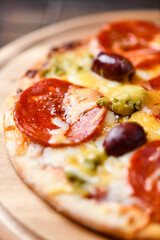 Pizza with chorizo ​​sausage, mozzarella and cheddar cheese, olive pesto and kalamata olives....