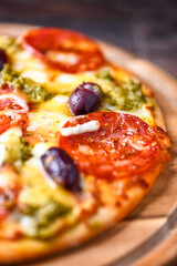 Pizza with chorizo ​​sausage, mozzarella and cheddar cheese, olive pesto and kalamata olives....