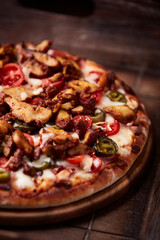 Gyros Pizza with jalapeno pepper, cherry tomatoes and mozzarella cheese. Soft focus. Close up.	