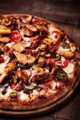 Gyros Pizza with jalapeno pepper, cherry tomatoes and mozzarella cheese. Soft focus. Close up.	