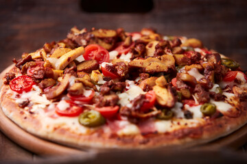 Gyros Pizza with jalapeno pepper, cherry tomatoes and mozzarella cheese. Soft focus. Close up.	