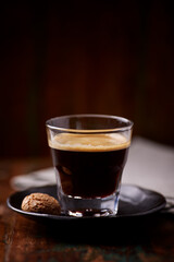 Coffee in glass cup on dark background. Close up. Copy space	