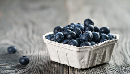 Fresh organic blueberries in biodegradable container. Tasty and sweet natural product.